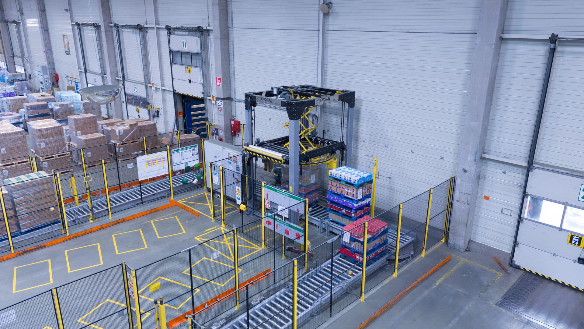 Overhead view of an automated pallet wrapping station at a HOPI dock