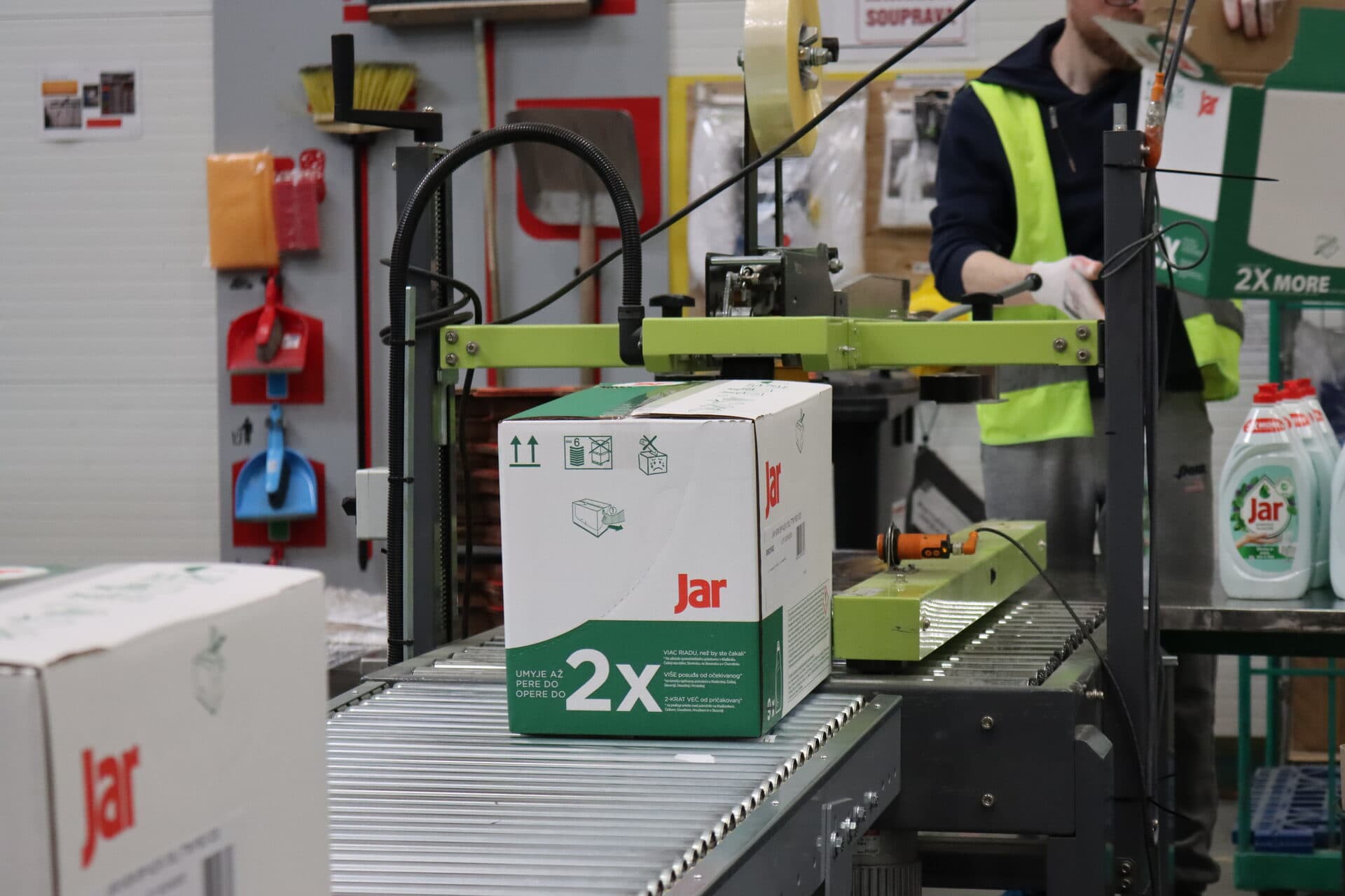 Jar cases being sealed on a HOPI VAS conveyor line